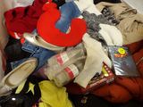 a pile of clothes and shoes in a box