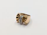 a close up of a gold ring with diamonds on a white surface