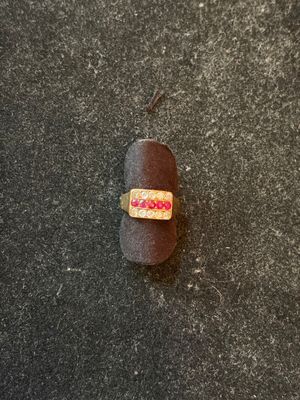 a ring that is on top of a rock on the ground