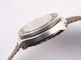 a close up of a watch on a white surface