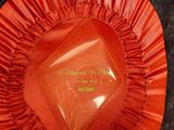 a close up of a red ribbon with a name on it