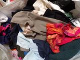 a pile of clothes that is sitting on the floor
