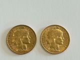 two pieces of gold coin with a woman ' s face on the front and a man ' s head on