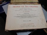 an old book sitting on top of a pile of books
