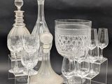 a lot of wine glasses and a decanter on the table