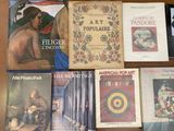 several books are sitting on a table in front of each other