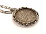 an image of a silver coin with a chain on a white background