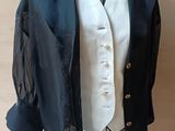 a suit on a mannequin with a white shirt and black jacket