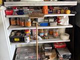 a refrigerator with many items on it in a garage