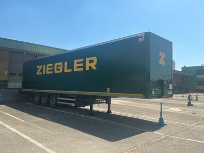 a large green truck that is parked in a parking lot