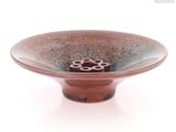 a brown bowl with a flower inside of it