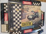 a box of scalexte racing toys on a table