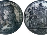two silver coins with a portrait of a man and a woman on them