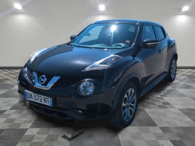 the black nissan juke is parked on a checkered floor