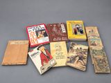 several books are arranged on a gray surface with a gray background