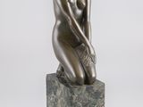 statue d'une femme assise sur un bloc de marbre