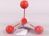 a red object that is sitting on a white surface