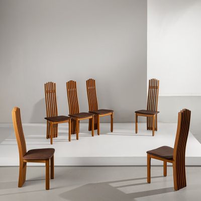 Plusieurs chaises en bois sont disposées en cercle sur une surface blanche