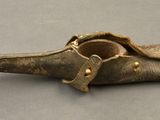 a small bronze object with a bird ' s beak on it
