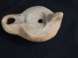 a small clay object with a hole in the middle