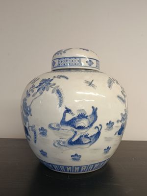 a blue and white vase with a monkey on it
