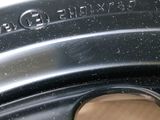 the rim of a car with a tire with a sticker on it