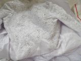 a picture of a white wedding dress on a bed