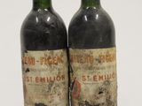 two bottles of wine sitting next to each other on a white surface