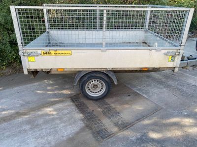 a small trailer with a cage on the back of it