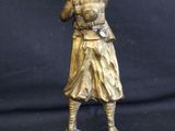 bronze statue of a man holding a baseball bat on a black background