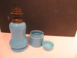 a blue vase and a blue cup sitting on a table