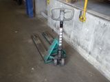 a scooter that is sitting on the ground next to a wall