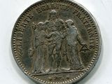 une vieille pièce d'argent sur laquelle figure l'image d'un groupe de personnes