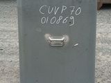 a trash can with a sign on it in front of a truck