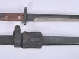 two knives are laying side by side on a white surface
