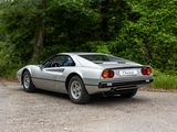 a silver sports car parked on the side of the road