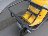 a yellow scooter parked on the side of the street