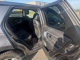 un SUV argenté dont la portière est ouverte sur la route