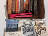 many old books in a box on a table