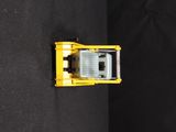 a yellow toy truck that is sitting on a black surface