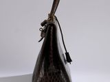 brown leather handbag on a white surface with a white background