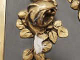 a picture of a pair of gold flowers on the wall