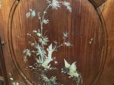 a wooden cabinet with a painting of birds on it