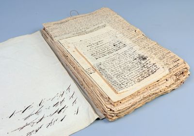 an old book with writing on it sitting on top of a table