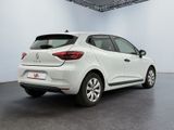 the rear end of a white car in a white room