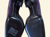 pair of black and purple shoes on a white background