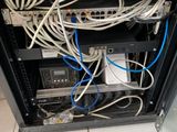 a rack with many wires in it on a tiled floor