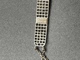 silver chain with a cell phone attached to it on a table
