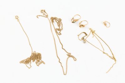 a lot of gold jewelry on a white surface