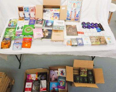 de nombreuses caisses de livres posées sur une table recouverte d'une nappe blanche